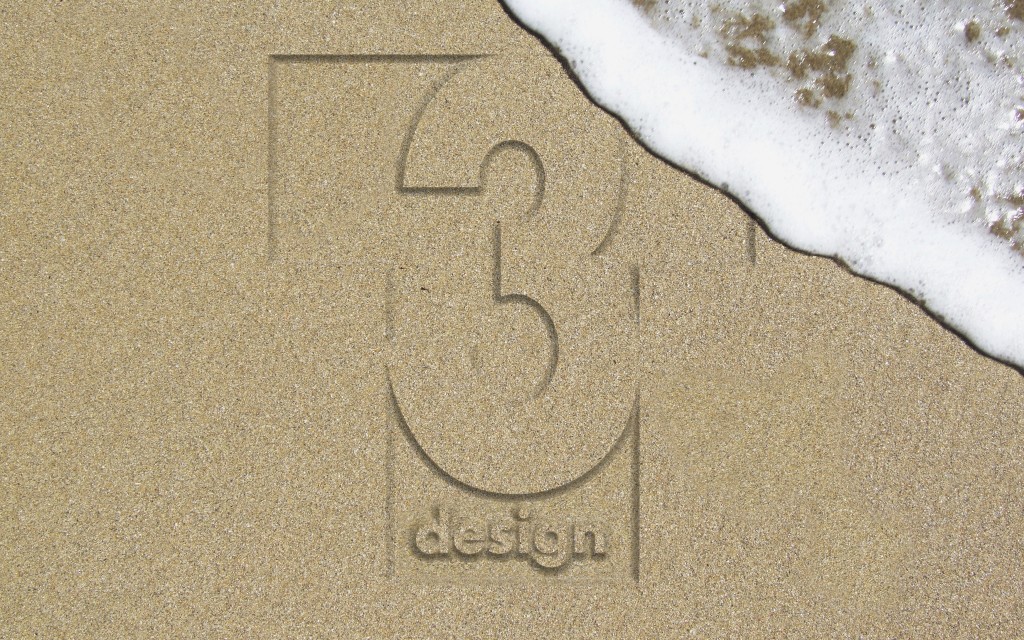 Female footprints on the beach with crestwaves coming from the side.